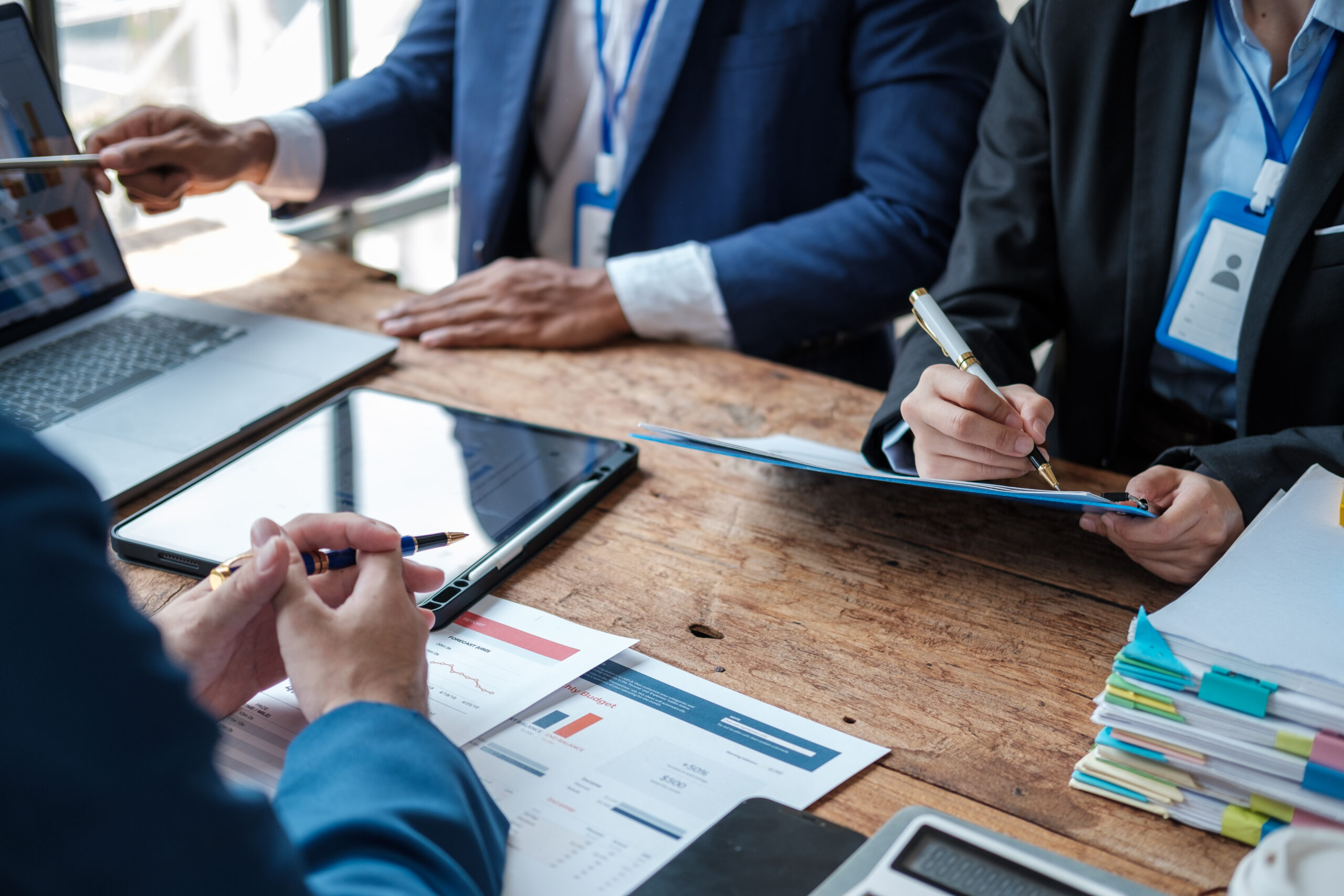 Business team analyzing income charts and graphs with modern laptop computer. Close up.Business analysis and strategy concept.