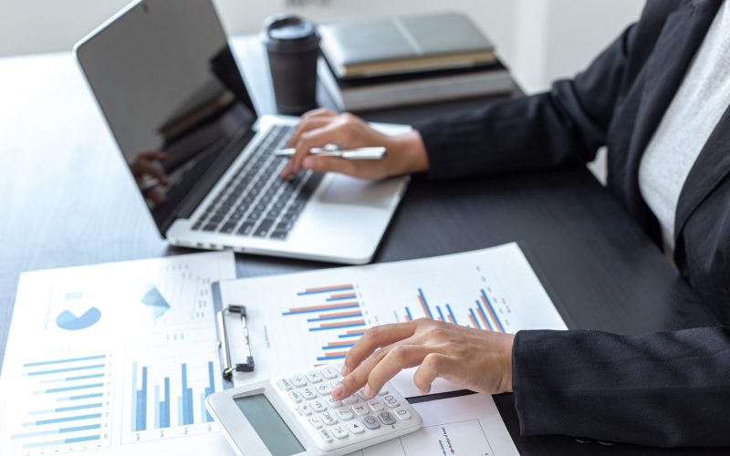 Accounting businessmen are calculating income-expenditure and analyzing real estate investment data, Financial and tax systems concept.